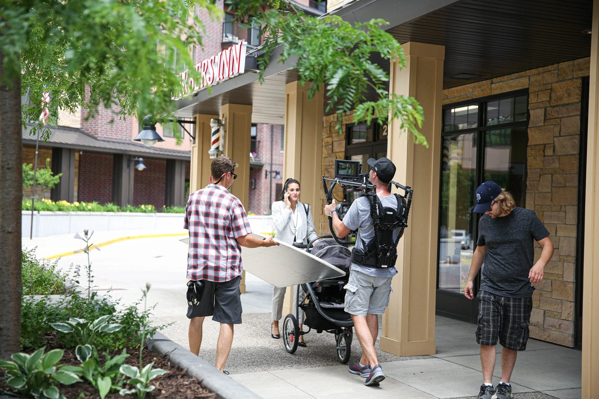 film crew filming a woman with a stroller for a commercial