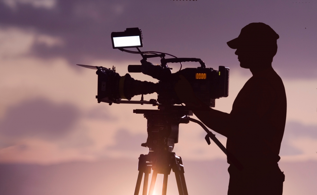 cinematographer operating a camera in silhouette
