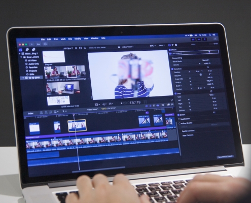 person editing with film production software