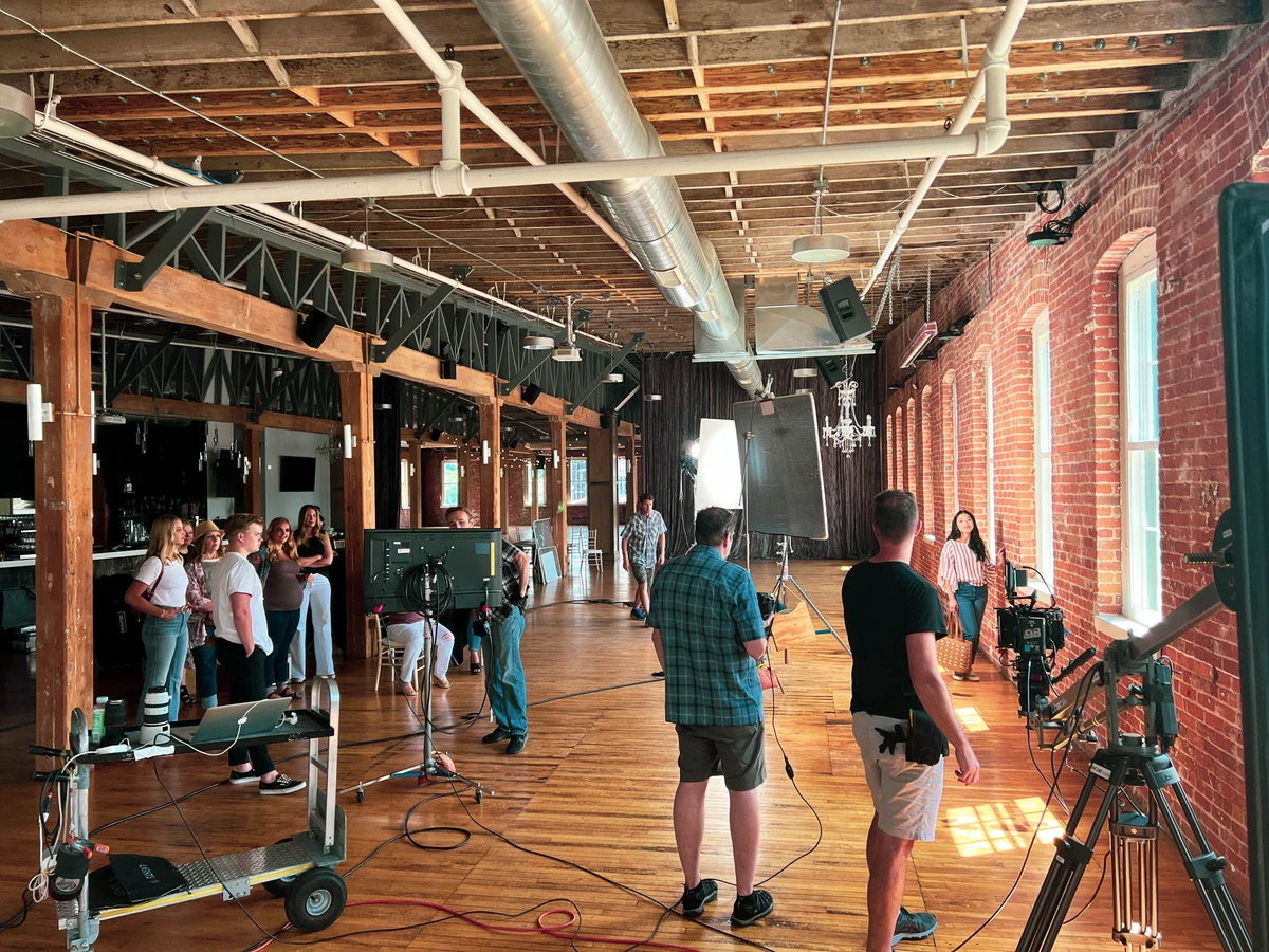 stringline videographers on set in a brick warehouse building
